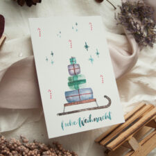 Weihnachtspostkarte „Geschenkeschlitten“
